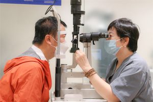 A picture containing person, clothing, job, scientific instrument Description automatically generated